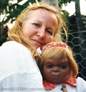 JABRO With Aboriginal Toddler Doll Looking at Viewer and Smiling