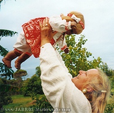 JABRO With Aboriginal Toddler Doll Looking at Viewer and Smiling